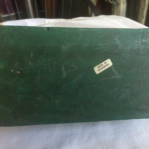 May include: A dark green wooden box with a white label that says "Made in Indonesia".