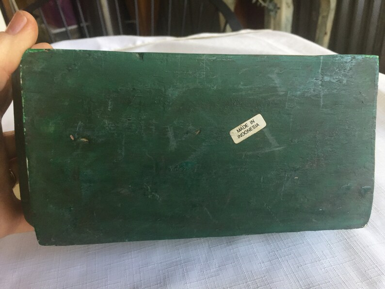 May include: A dark green wooden box with a white label that says "Made in Indonesia".