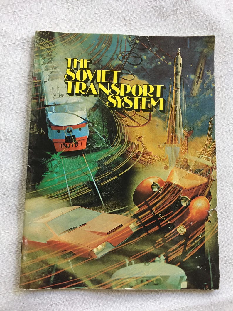 May include: A vintage book cover with a colorful illustration of a train, car, and rocket ship. The title of the book is "The Soviet Transport System".