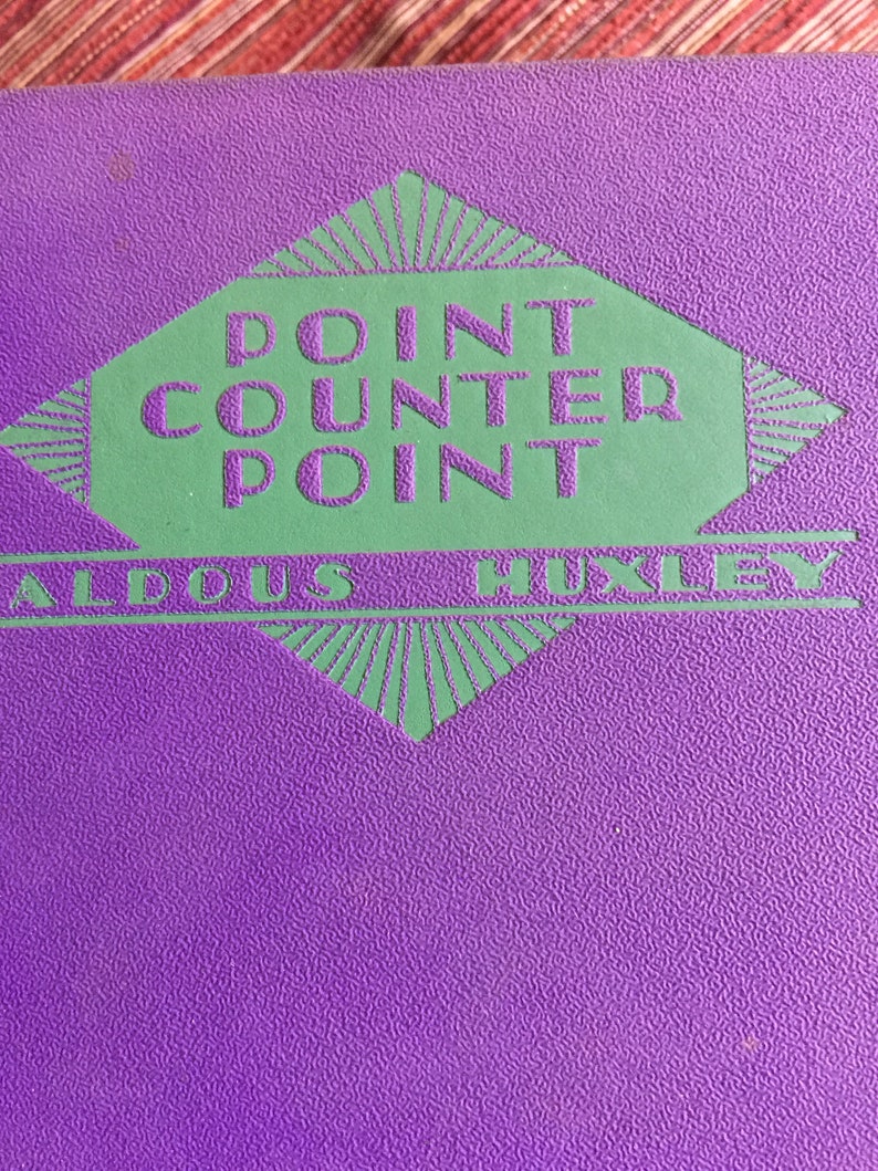 May include: Purple book with a green diamond-shaped logo that says "Point Counter Point" in a vintage font.