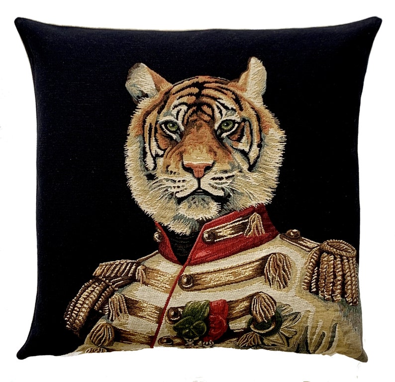 May include: A black and white tapestry cushion featuring a tiger wearing a military uniform with gold trim and a red sash. The tiger has a serious expression and is looking directly at the viewer.