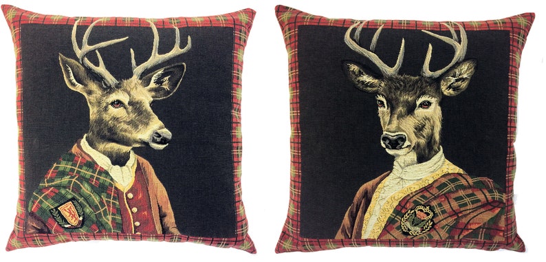 May include: Two decorative throw pillows with a black background and red and green tartan trim. Each pillow features a portrait of a deer wearing a tartan kilt and a white shirt.