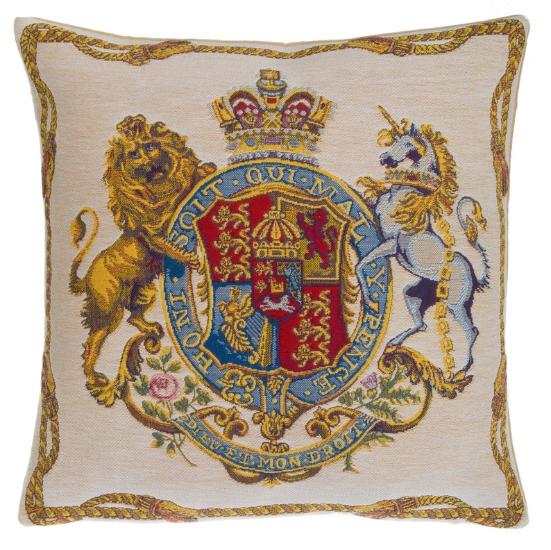 May include: A square throw pillow featuring a woven tapestry design of the British Royal Coat of Arms. The central shield is flanked by a golden lion and a silver unicorn, topped with a crown, and surrounded by a rope-style border on a beige background.