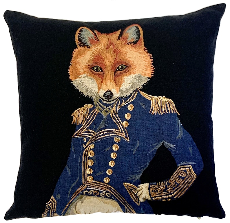 May include: A black velvet pillow with a tapestry design of a fox wearing a blue military uniform with gold buttons and trim.