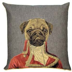 May include: A square throw pillow featuring a woven tapestry design of a pug dog dressed in a red military-style jacket with gold trim and a white cravat. The background of the pillow is a textured dark gray fabric, creating a portrait-style image.