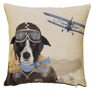 May include: A square throw pillow featuring a woven tapestry design of a black and white dog dressed as an aviator. The dog wears a brown leather helmet with goggles, a tan fur-lined collar, and a blue scarf. A vintage biplane flies in the background.