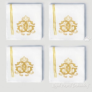 May include: Four white linen napkins with gold embroidered initials and a gold border. The initials are in a script font and are centred on the napkin. The napkins are arranged in a square pattern.