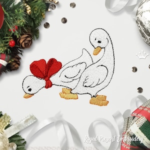 May include: Embroidered design of two white geese with a red bow on one of the geese's necks. The geese are standing on yellow feet and have black eyes.
