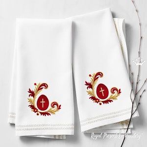 May include: Two white kitchen towels with embroidered red and gold Easter egg designs. Each design features a red egg with a gold cross and gold floral accents.