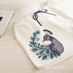 May include: White pajama shorts with an embroidered peacock design. The peacock is purple, teal, and gold. The text "Royal Present Embroidery" is at the bottom of the shorts.