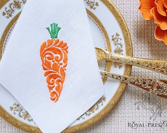 Peut inclure: Une serviette en lin blanc avec un motif de carotte orange brodé. La carotte est stylisée avec un motif floral.
