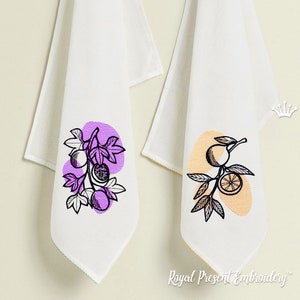 May include: Two white kitchen towels with embroidered fruit designs. One towel features a purple passion fruit branch with leaves, the other features a yellow orange branch with leaves. Both towels have a white background and a black outline.