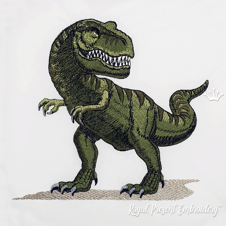May include: Green embroidered dinosaur with sharp teeth and claws, standing on a tan surface. The dinosaur is facing right and has a long tail.