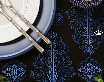 May include: A black tablecloth with a blue embroidered design. The tablecloth is set with a white plate, a blue plate, and two silver utensils. The text "Royal Present Embroidery" is visible in the bottom right corner of the image.