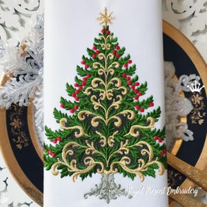 May include: Embroidered Christmas tree design on white fabric. The tree features green leaves, red berries, and gold filigree accents. A gold star tops the tree, and the base is silver. The text "Royal Present Embroidery" is at the bottom.
