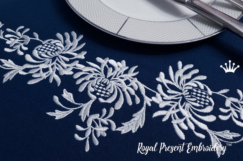 May include: Navy blue embroidered table runner with a white floral design. The runner features a repeating pattern of stylized flowers and leaves. A white plate and silverware are visible in the background. The text "Royal Present Embroidery" is at the bottom.