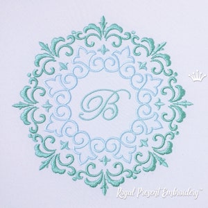May include: An embroidered design featuring a circular frame with ornate teal and light blue floral patterns. The letter "B" is centered within the frame. The design includes the text "Royal Present Embroidery".