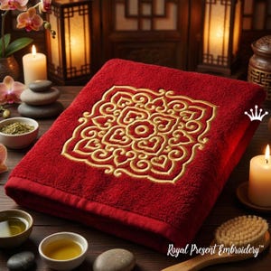 May include: A plush, red bath towel with an embroidered gold floral design. The towel features a detailed, symmetrical pattern in the center. The text "Royal Present Embroidery" is visible in the bottom right corner.