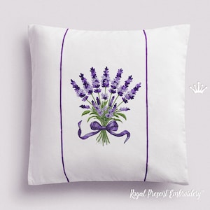 May include: White pillow with a purple lavender flower embroidery design. The pillow has two purple stripes on the sides.