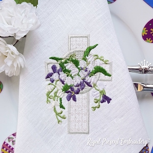 May include: White linen napkin with an embroidered design of a white cross with a wreath of white flowers and purple flowers around it. The text "Royal Present Embroidery" is at the bottom of the napkin.