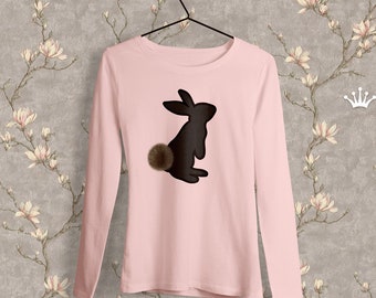 May include: A pink long-sleeved t-shirt with a black silhouette of a rabbit with a brown fluffy tail.
