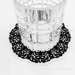 May include: Black and white embroidered coaster with a delicate floral design. The coaster is round and has a white border. The text "Royal Present Embroidery" is visible in the bottom right corner.