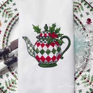 May include: Embroidered design of a red, white, and green teapot with holly leaves and berries. The teapot is on a white background with the text "Royal Present Embroidery" at the bottom.