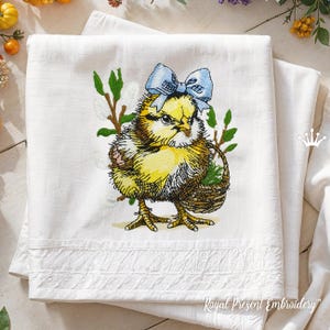 May include: Embroidered design of a yellow chick with a blue bow, holding a basket of flowers. The chick has an angry expression and is surrounded by green leaves and white flowers.