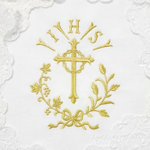 May include: White embroidered cloth with a gold cross, the letters IHS, and a wreath of leaves and grapes. The design is surrounded by a delicate lace border. The words "Royal Present Embroidery" are at the bottom.