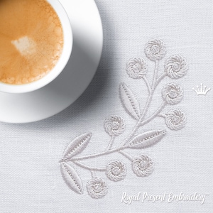 May include: White embroidered floral design on a white linen fabric. The design features a delicate stem with leaves and small white flowers.