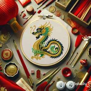 May include: A close-up of a gold and green embroidered dragon on a white fabric stretched over a wooden embroidery hoop. The hoop is surrounded by various craft supplies, including red and gold tassels, paintbrushes, and a small red lantern.