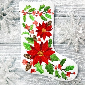May include: White Christmas stocking with red poinsettia flowers, green holly leaves, and red berries embroidered on it. The stocking is on a white wooden background.