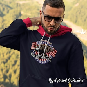 May include: Navy blue hoodie with a red-lined hood and cuffs. The front features an embroidered design of an eagle, American flags, and the text "IN GOD WE TRUST" and "UNITED STATES OF AMERICA".