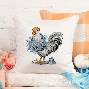 May include: Embroidered cushion featuring a black and white rooster with a blue flower wreath around its neck. The rooster is standing on a white background.