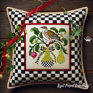 May include: A white and black checkered pillow with a red border and a cream colored border. The pillow features an embroidered design of a bird perched on a branch with pears and a radish. The design is framed in a red and cream colored border. The text "Royal Present Embroidery" is printed on the bottom of the pillow.