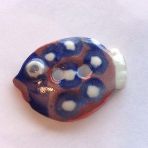 Cute as all get-out, one-of-a-kind, fish-shaped,  red, white & blue, circle-patterned, 1.5-inch, handmade porcelain ceramic button