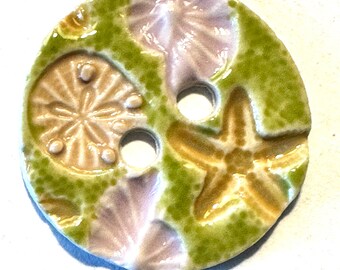 Beach finds! 1.54-inch handmade buttons porcelain ceramic pastel lilac yellow beige starfish sand dollars seashells on lime green seashore