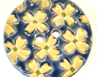 Jumbo delight. 2.40-inch handmade porcelain ceramic extra large sewing button, lime green-centered yellow dogwood-like flowers on blue