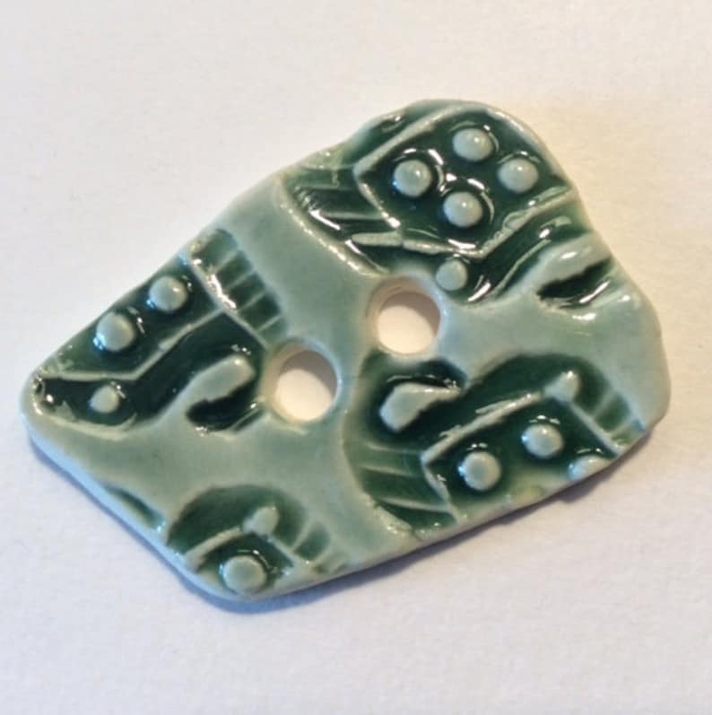 1.5-inch button Unique one of a kind glossy forest green celadon with original motif handmade porcelain ceramic pottery
