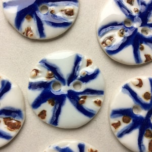 Cobalt blue, white and rust red 1 and 1/8-inch circular porcelain ceramic buttons