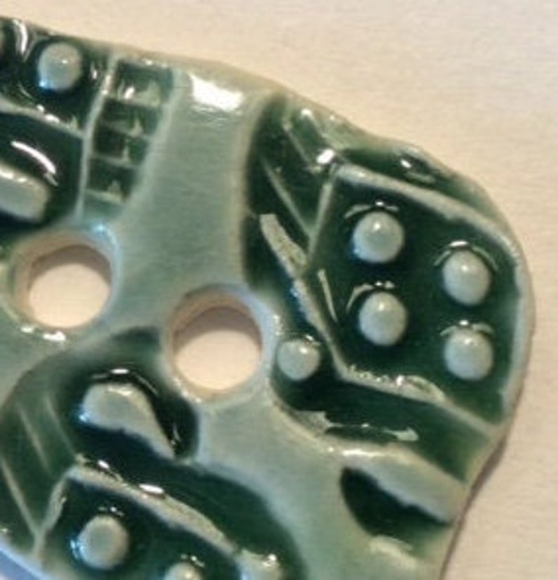 1.5-inch button Unique one of a kind glossy forest green celadon with original motif handmade porcelain ceramic pottery