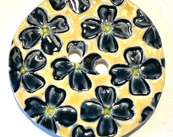 Jumbo delight. 2.38-inch handmade porcelain ceramic extra large sewing button indigo navy blue dogwood-like flowers on yellow dated 2024