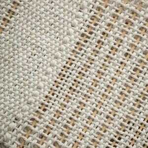 Close-up detail of woven cotton texture on a Japandi-inspired minimalist tapestry, showcasing intricate craftsmanship.