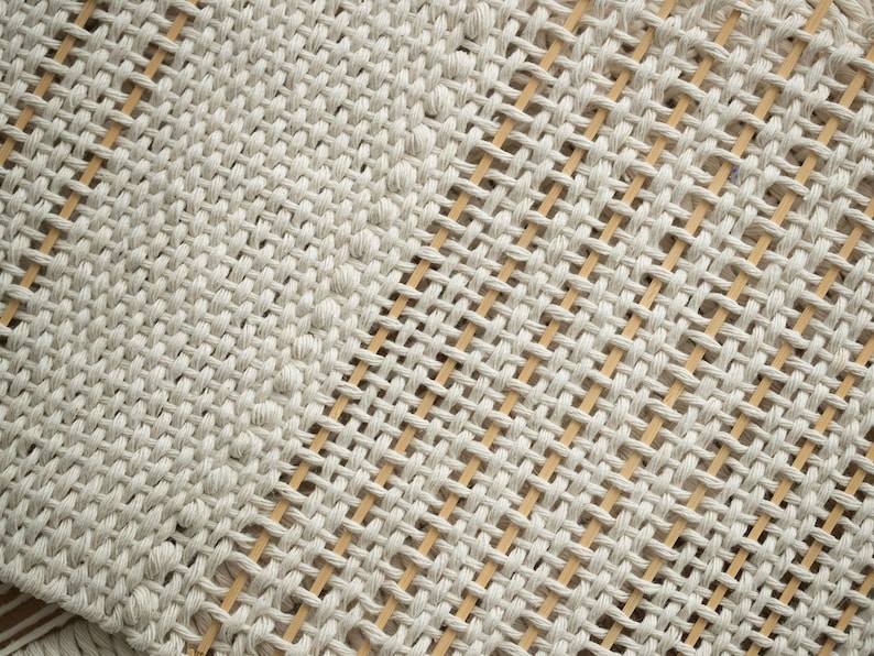 Close-up detail of woven cotton texture on a Japandi-inspired minimalist tapestry, showcasing intricate craftsmanship.