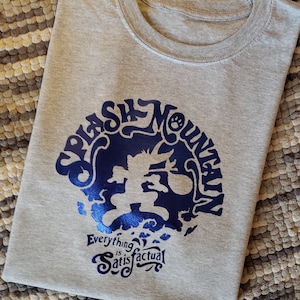 May include: Gray t-shirt with a blue graphic of a cartoon character running with a bag. The graphic is surrounded by the text "Splash Mountain" and the text "Everything is Satisfactual".