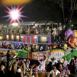 May include: A colorful Mardi Gras float with a large jester head, decorated with green, purple, and gold. The float is surrounded by people cheering and waving their hands in the air. The text "PHOTOGRAPHY BY LOUIS" is visible in the bottom right corner of the image.