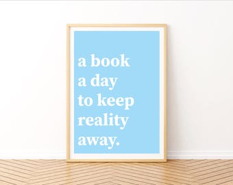 May include: A light blue framed print with the text "a book a day to keep reality away."