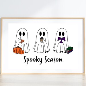 May include: Three white ghosts with different activities: one carving a pumpkin, one holding a cup of coffee, and one reading a book. The text "Spooky Season" is below the ghosts.