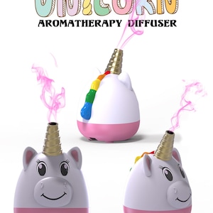 May include: Aromatherapy diffuser in the shape of a unicorn. The diffuser is white with a pink base and a gold horn. The word "UNICORN" is written above the diffuser in colorful letters. Pink vapor is coming out of the horn.