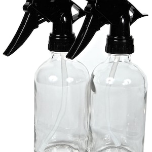May include: Two clear glass spray bottles with black trigger sprayers. The bottles are empty and ready to be filled with your favorite liquids.